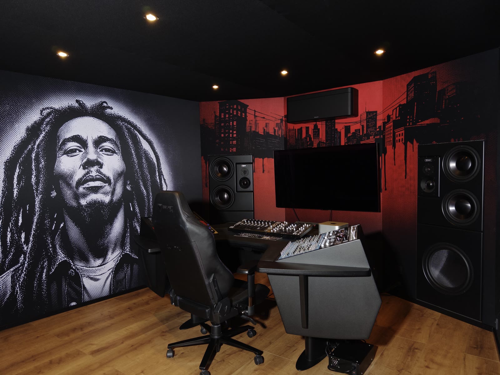 Left side of the room: portrait mural beside the red comic-style skyline and the flush-mounted monitor wall.