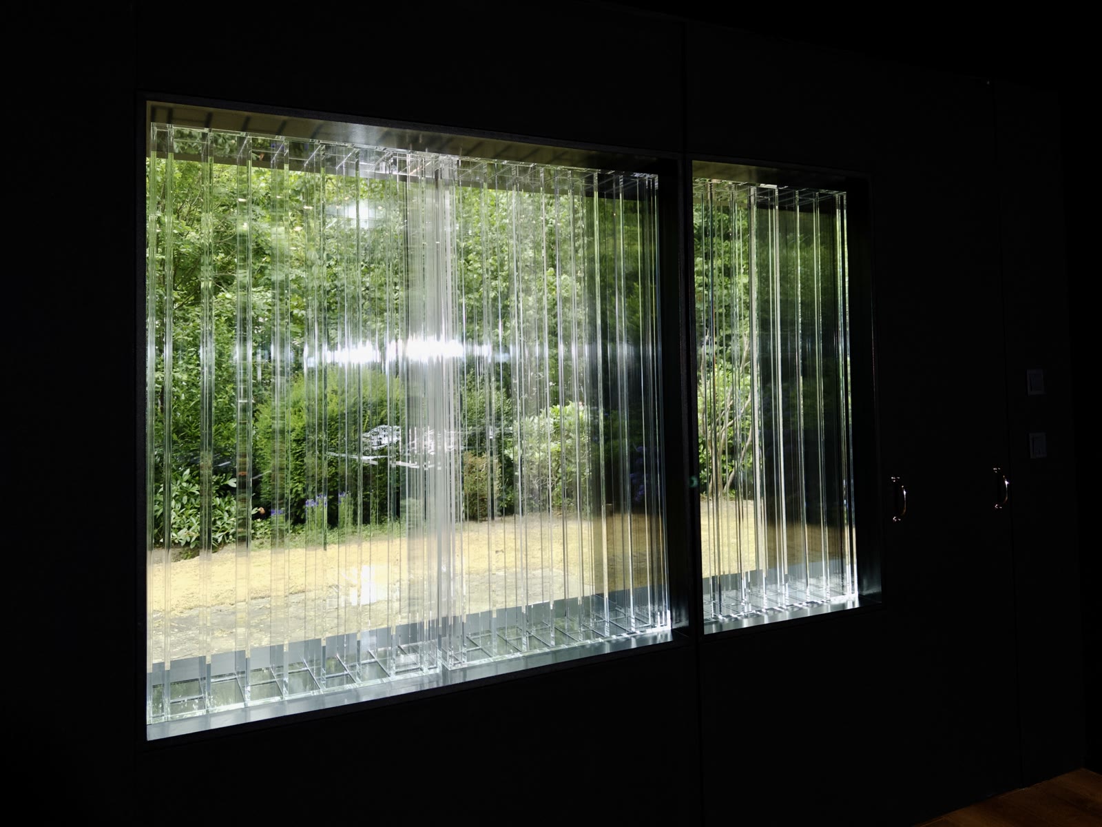 Close view of the Lightffusor diffuser slats with the green garden behind.