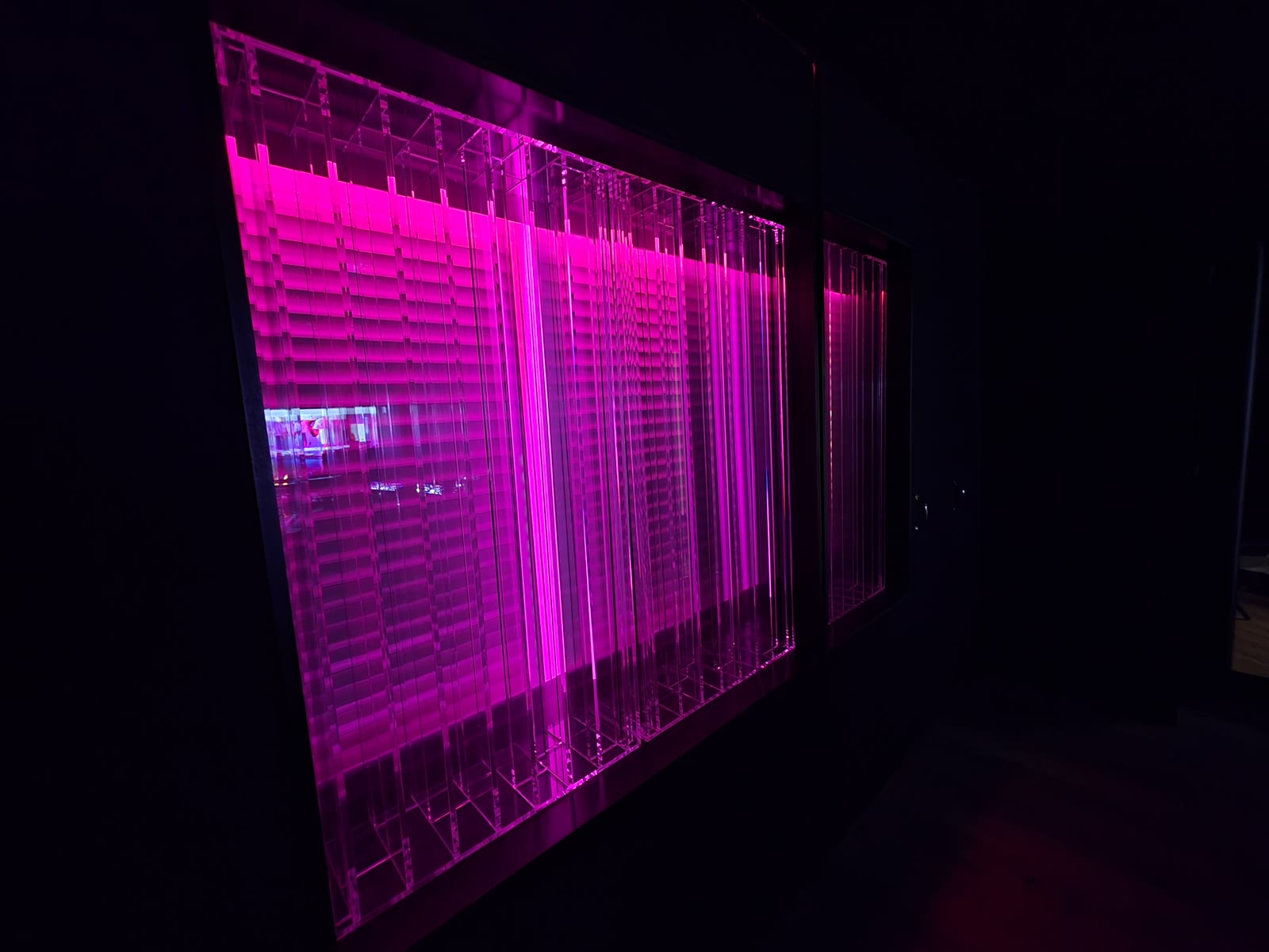 Side view of the glowing Lightffusor diffuser panels in magenta light.