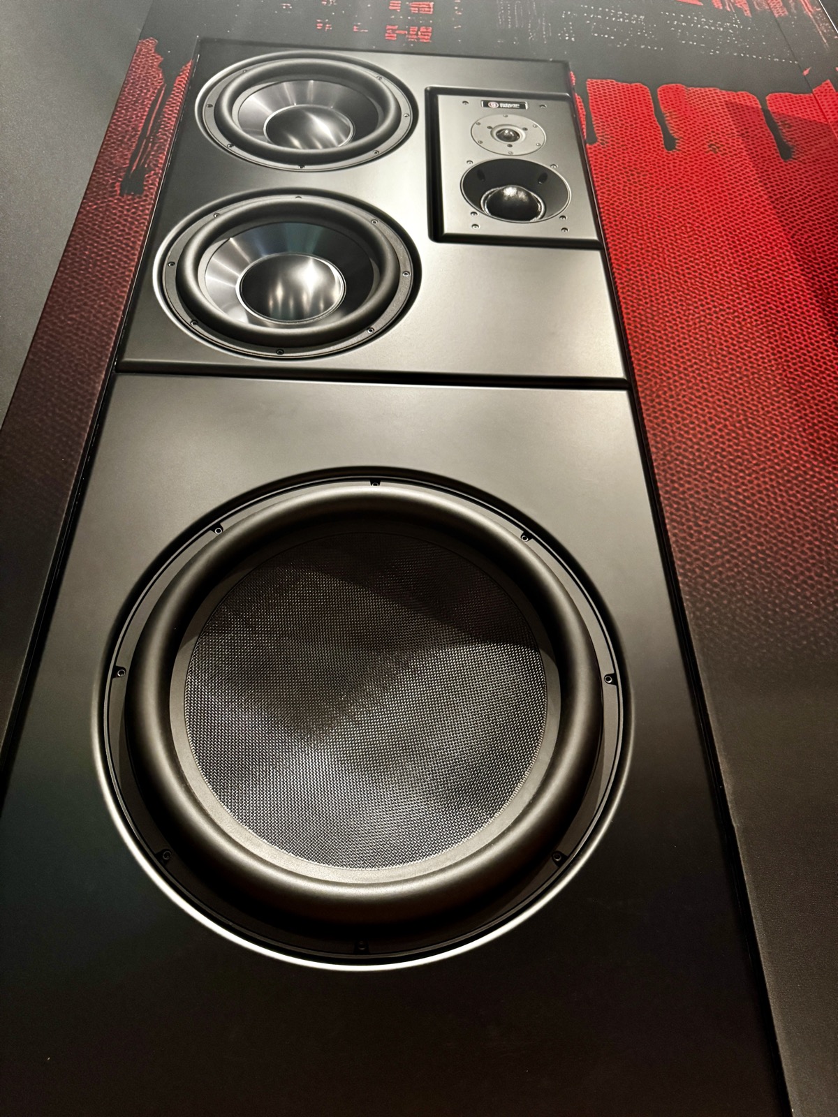 Guzauski Swist GS4 main monitor and GS18 subwoofer flush-mounted into the artwork wall